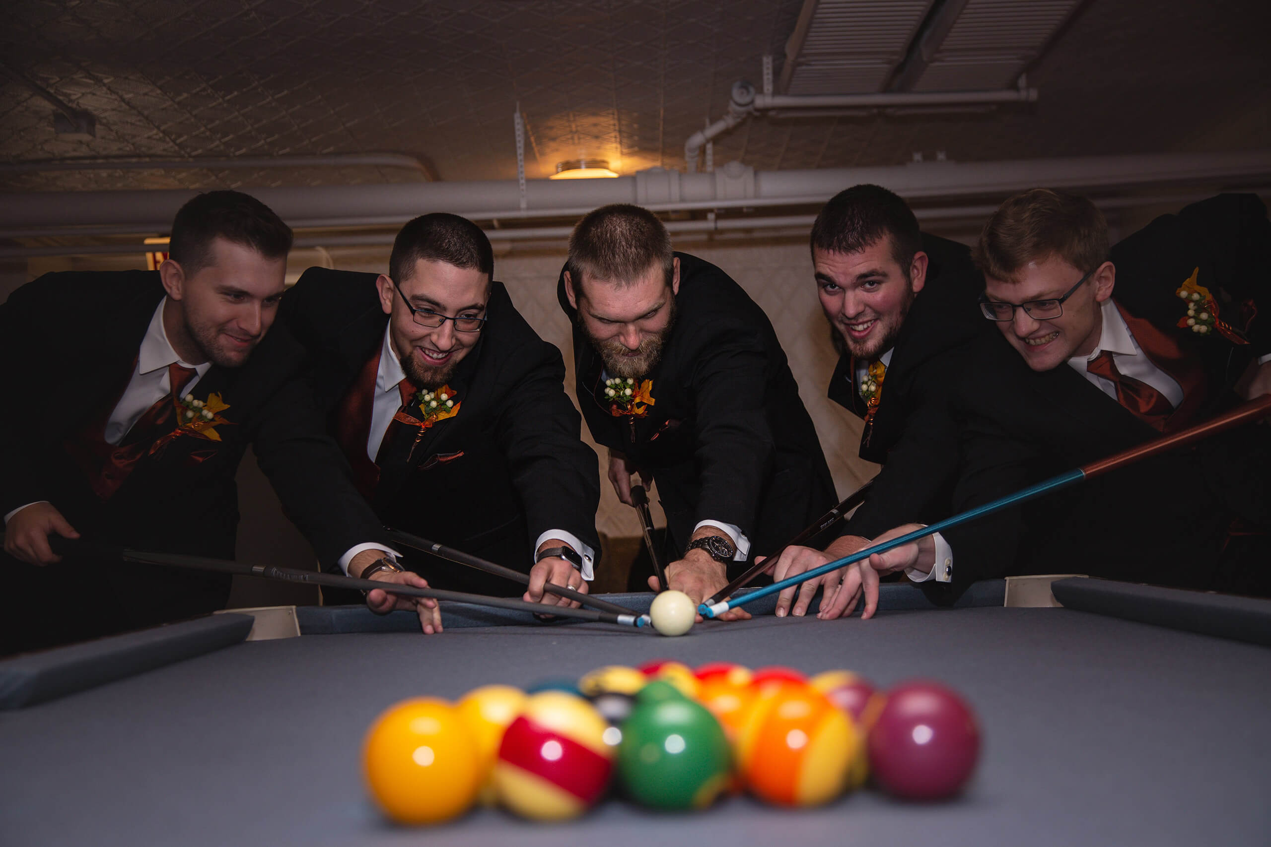 Men standing around a pool table at Best Wedding Venue Green Bay