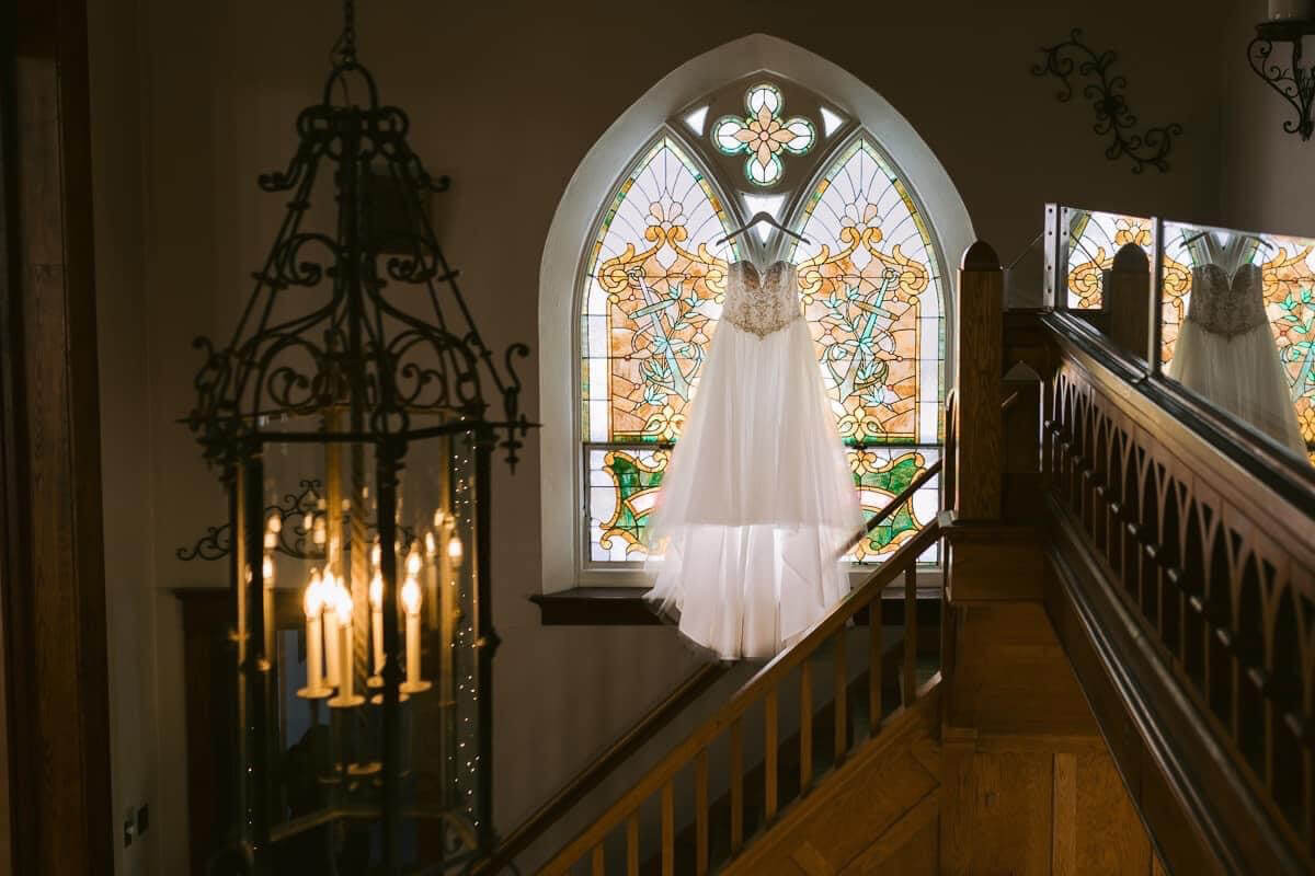 wedding dress hanging in devotions wedding chapel